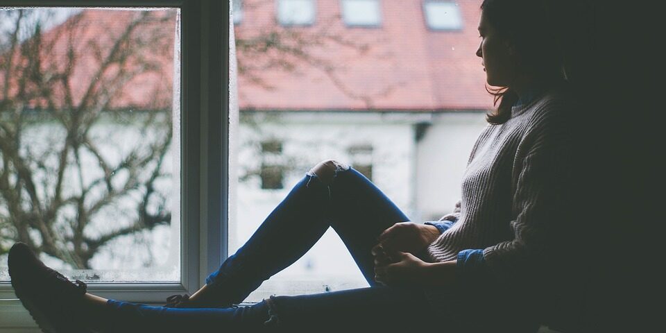 Young Woman Looking Out A Window